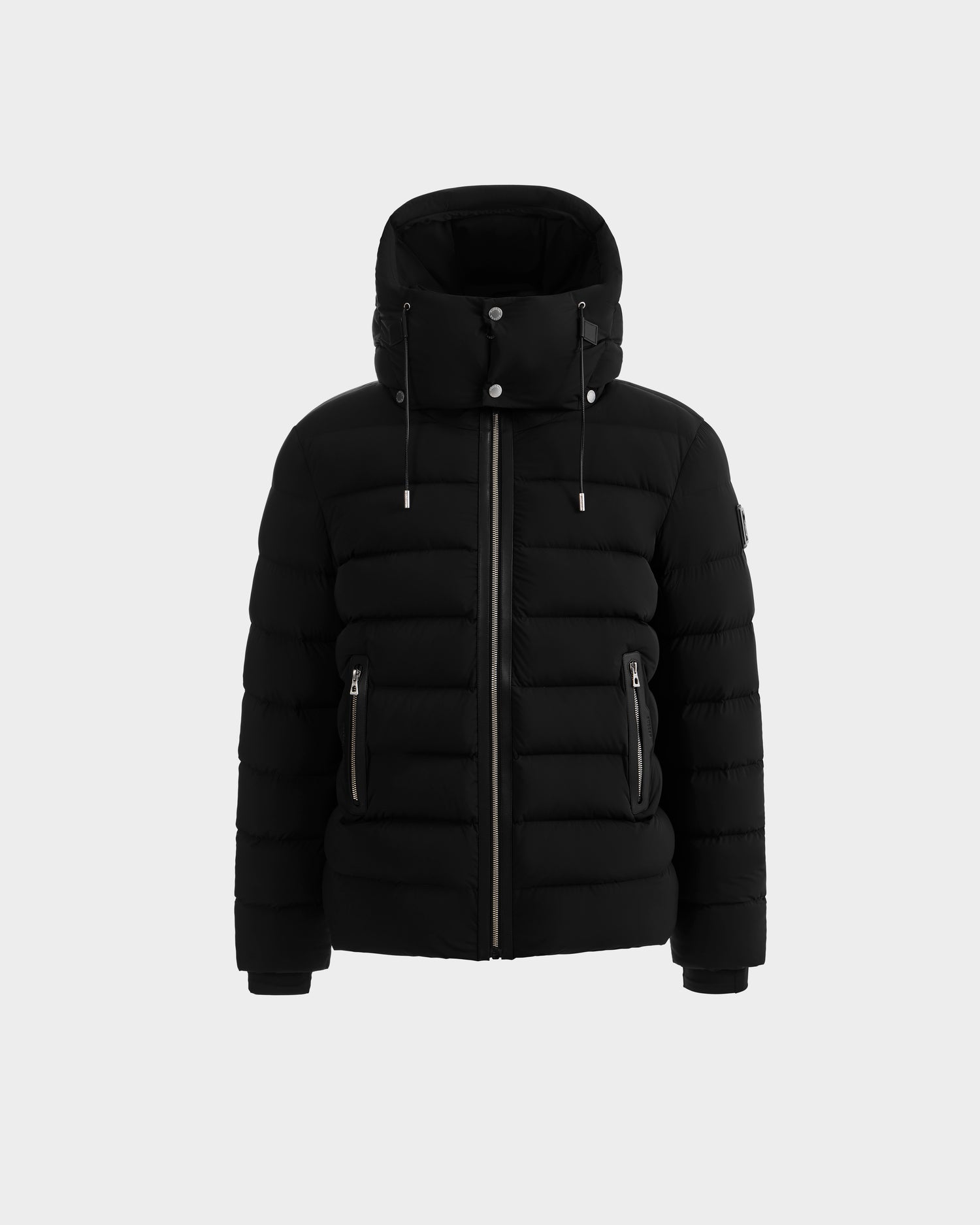 The Rudsak NAVAN - 6125598 Black men’s down puffer features RDS-certified down, high collar, detachable hood, front zipper, and two zippered side pockets, shown against a plain light background.