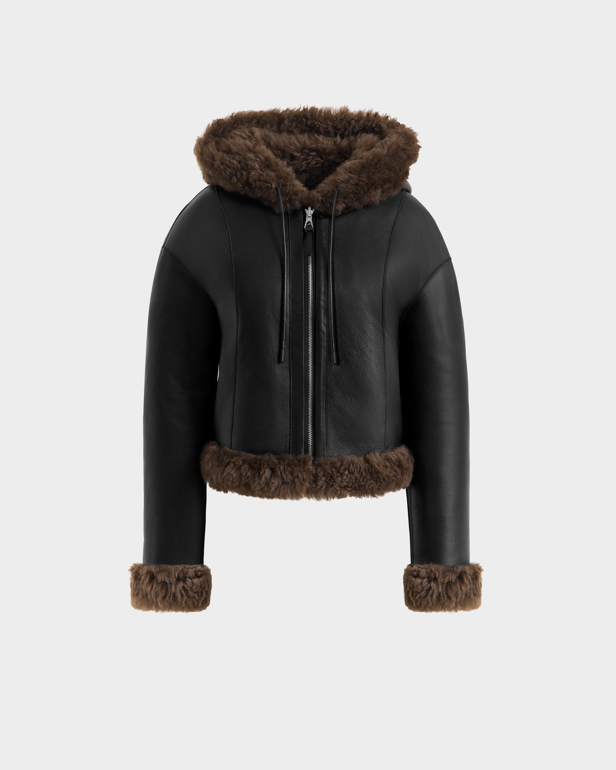 The Rudsak NORAH - 8125506 Black/Espresso women’s leather jacket features brown faux fur trim on the hood, cuffs, and hem. This cropped outerwear has a zipper front and is displayed on a plain light gray background.