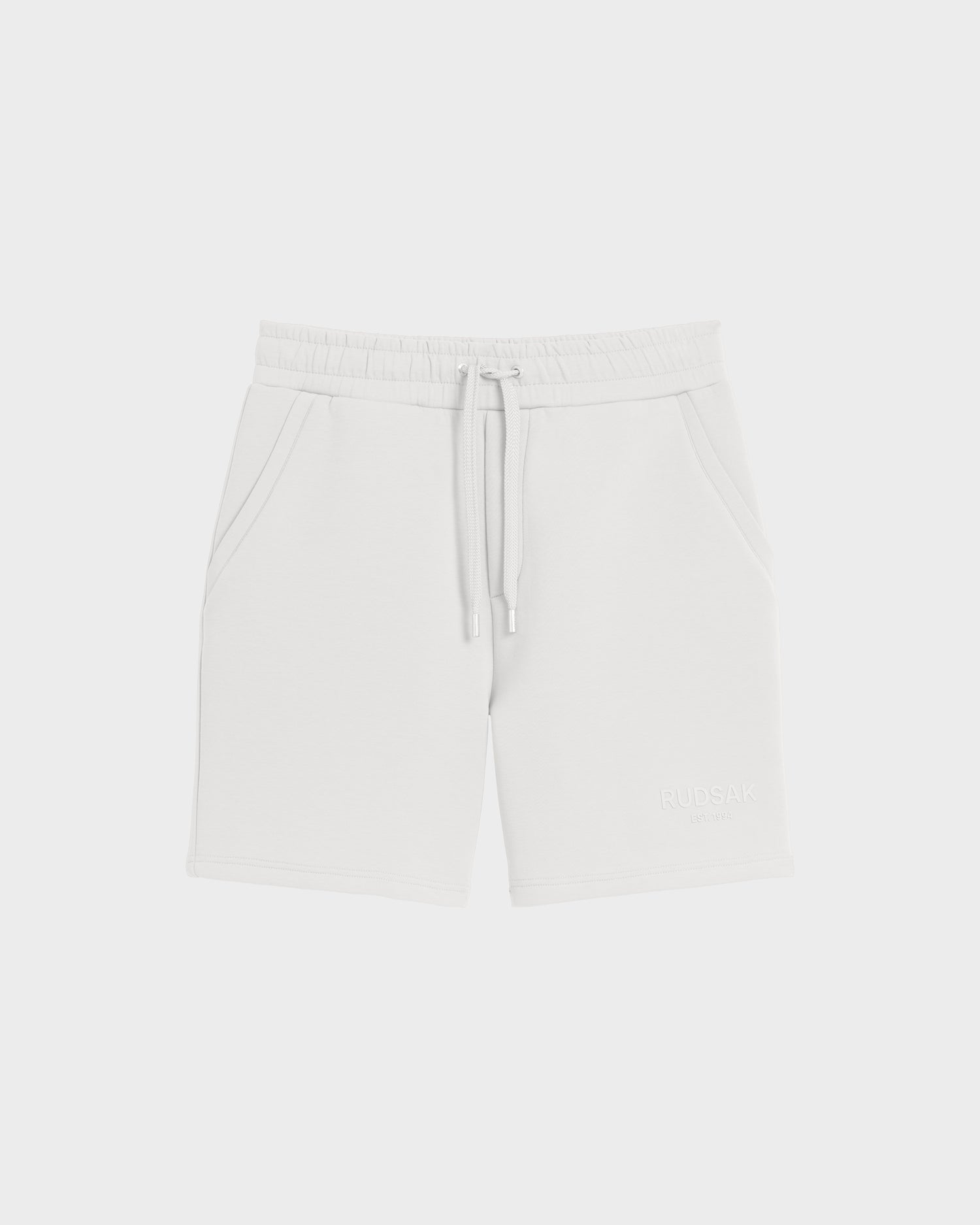 PASCAL - 6524022 ICELAND white men's jersey shorts by Rudsak, featuring a stretch comfort waistband, drawstring tie, side pockets, and a subtle Rudsak logo on the lower left leg. Displayed against a plain white background.