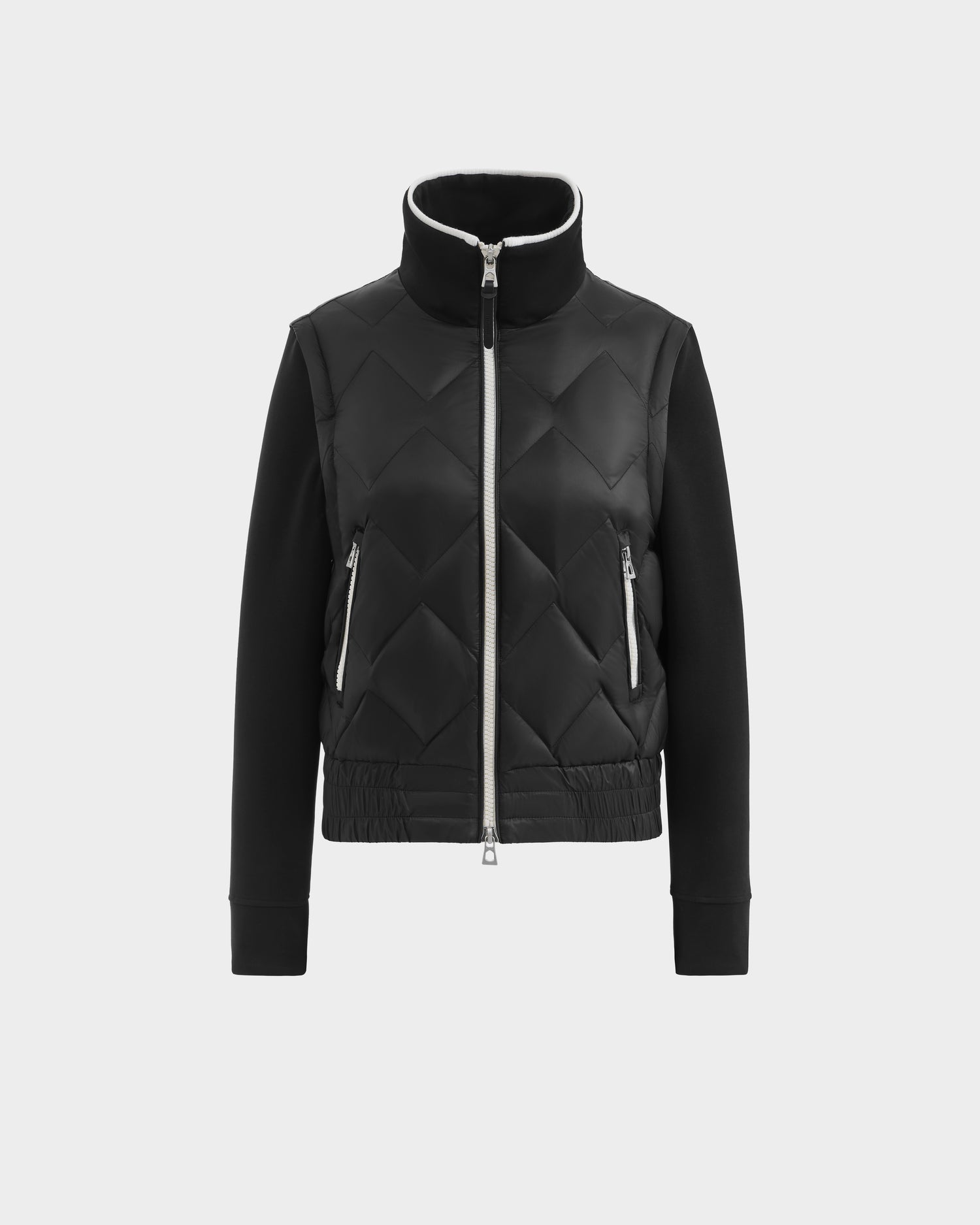 The Rudsak PRISA - 8126022 Black is a black quilted jacket with a high collar, two zippered side pockets, front zipper, and fitted hem. Removable sleeves let you easily convert it into a stylish vest.