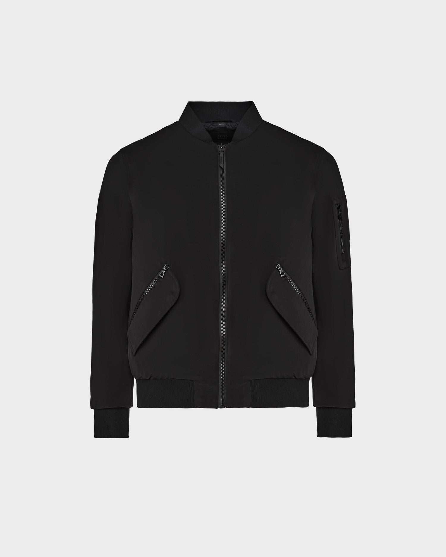 The Rudsak RICO - 6124021 Black mens bomber jacket features a front zipper, two diagonal zippered pockets, a zippered sleeve pocket, and a lightweight stretch shell for comfort, shown on a plain white background.