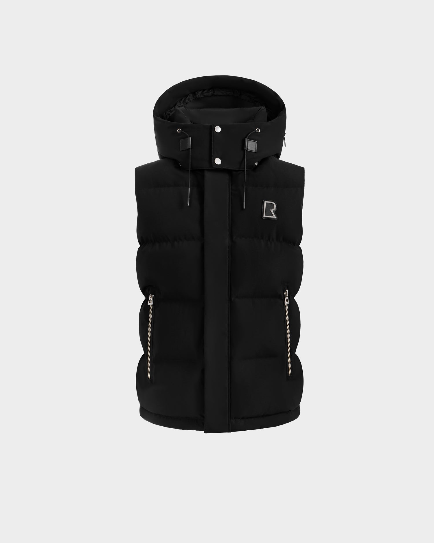 The Rudsak REN H - 6125688 Black men’s quilted down puffer vest features a removable hood, front zipper, two side zippered pockets, and a small R logo on the chest, shown against a plain light gray background.