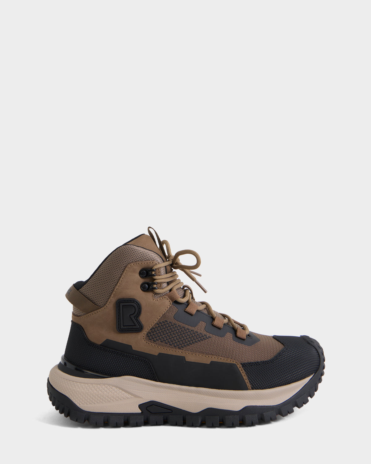 The Rudsak REXON - 6226503 Cement hiking boot features a brown and black colorway with rugged tread, mesh and synthetic overlays, a lace-up front, and a thick beige sole, shown against a plain white background.
