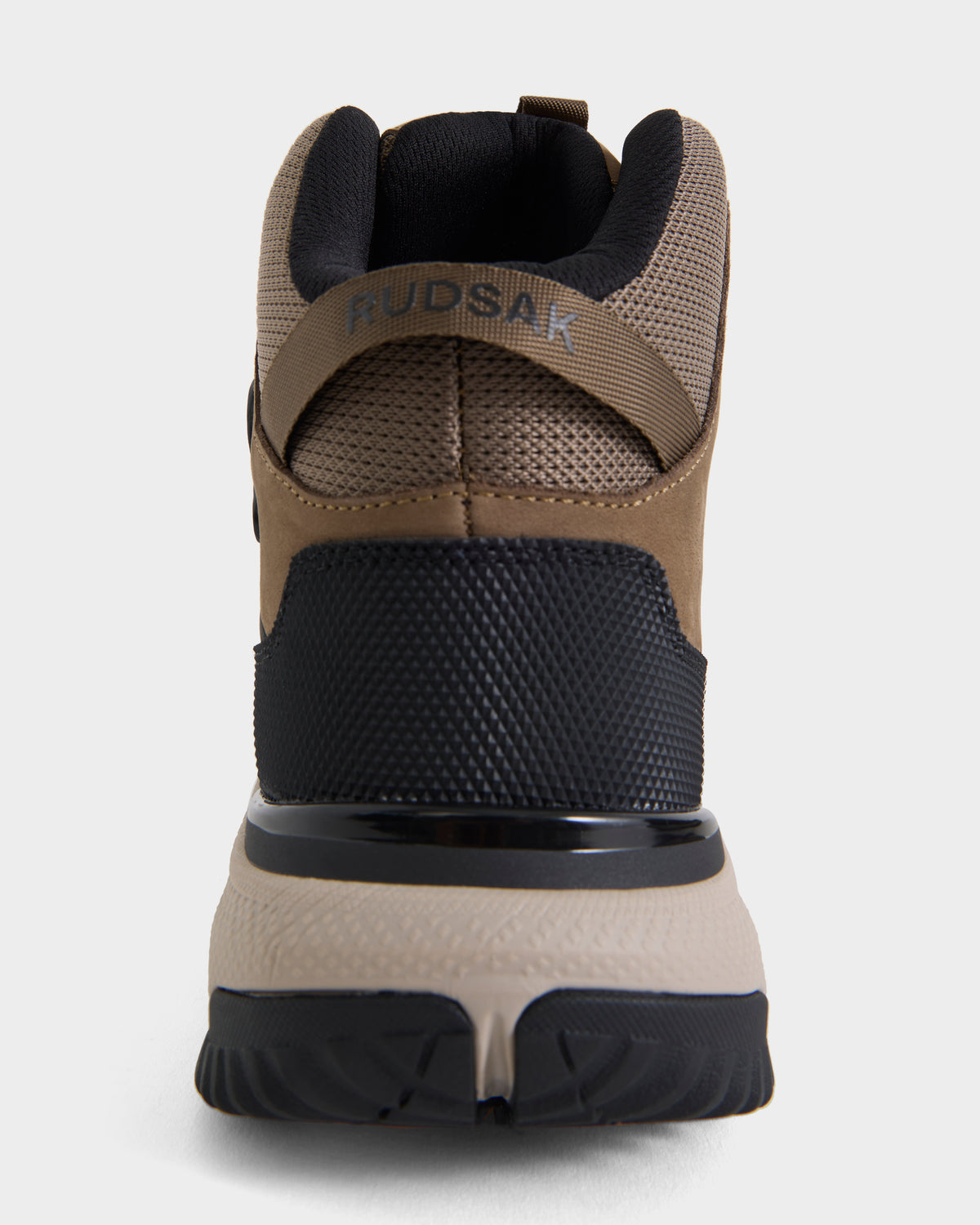 A rear view of the REXON - 6226503 Cement high-top sneaker by Rudsak, showcasing brown, black, and beige tones with mesh and textured details on the upper, a thick treaded sole, and “RUDSAK” text on the heel strap.