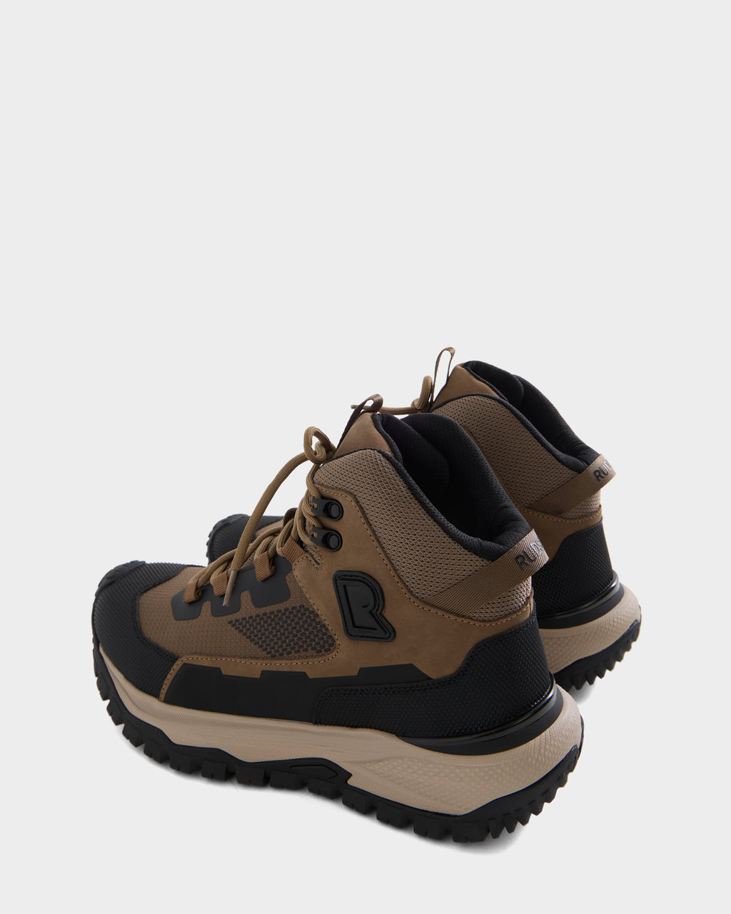 A pair of Rudsak REXON - 6226503 Cement hiking boots in brown and black, featuring thick soles, black accents, and mesh detailing. Positioned on a white background and angled slightly backward—ideal for anyone looking for a stylish yet durable winter boot.