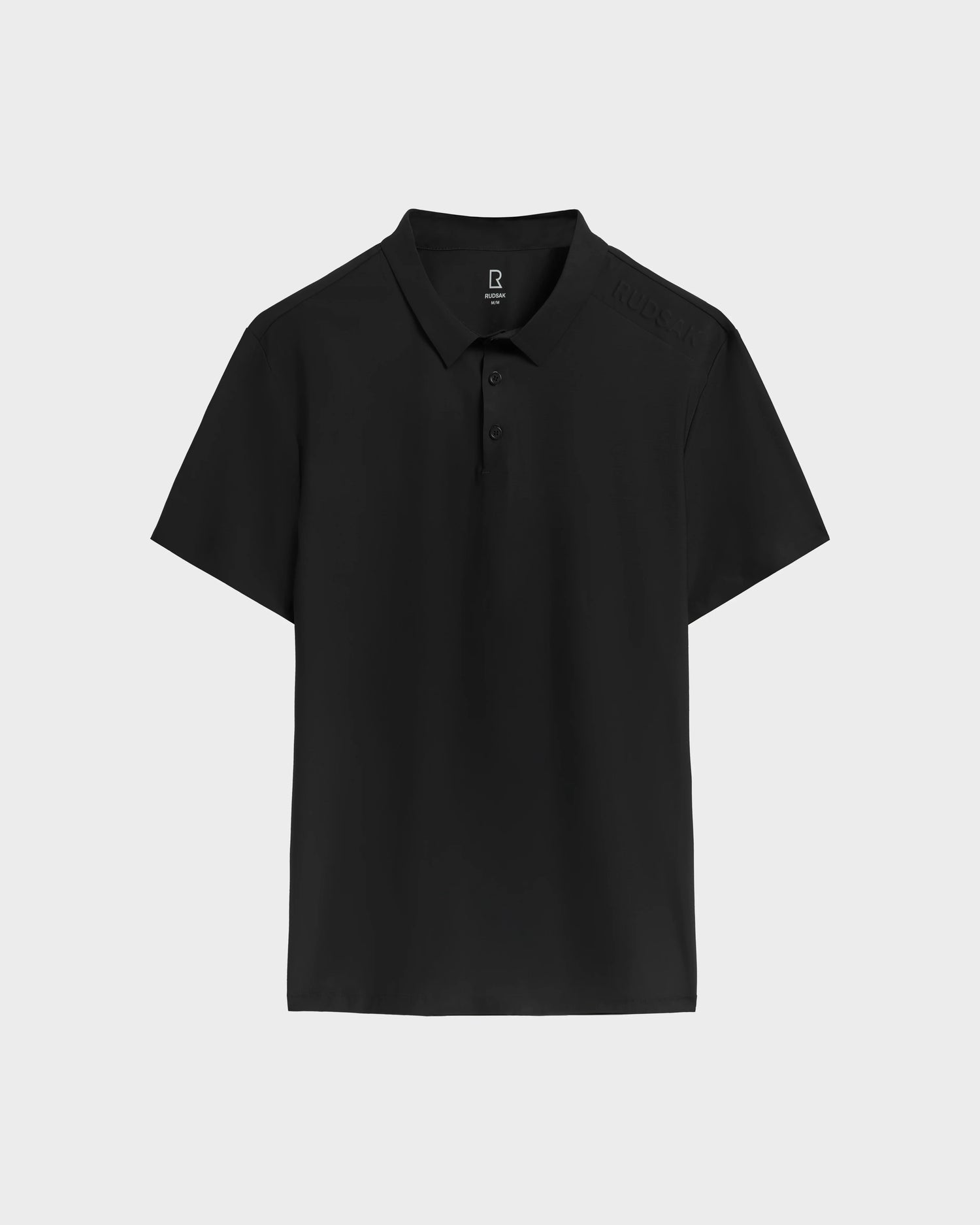 The RICKIE - 6525016 Black polo by Rudsak is a men’s classic, crafted from lightweight technical fabric with a collar and three buttons, shown in plain black on a light gray background.
