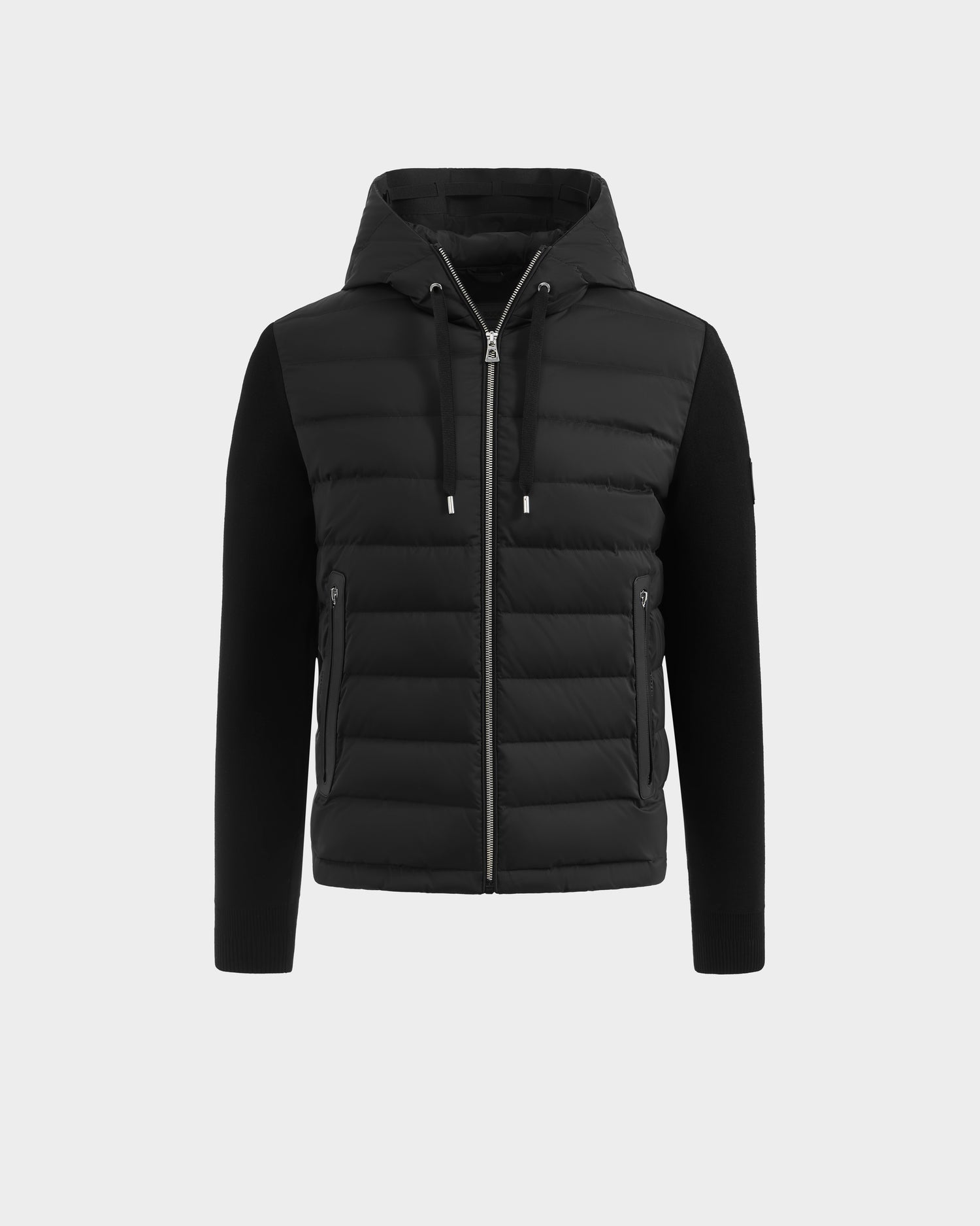 The Rudsak RIVER - 6124584 Black hybrid men's jacket features a quilted, padded front with a zip closure, adjustable drawstrings on the hood, and side zip pockets. The sleeves and sides are crafted from a smoother fabric for contrast and comfort. Shown on a plain white background, this stylish hooded down jacket combines function and fashion.