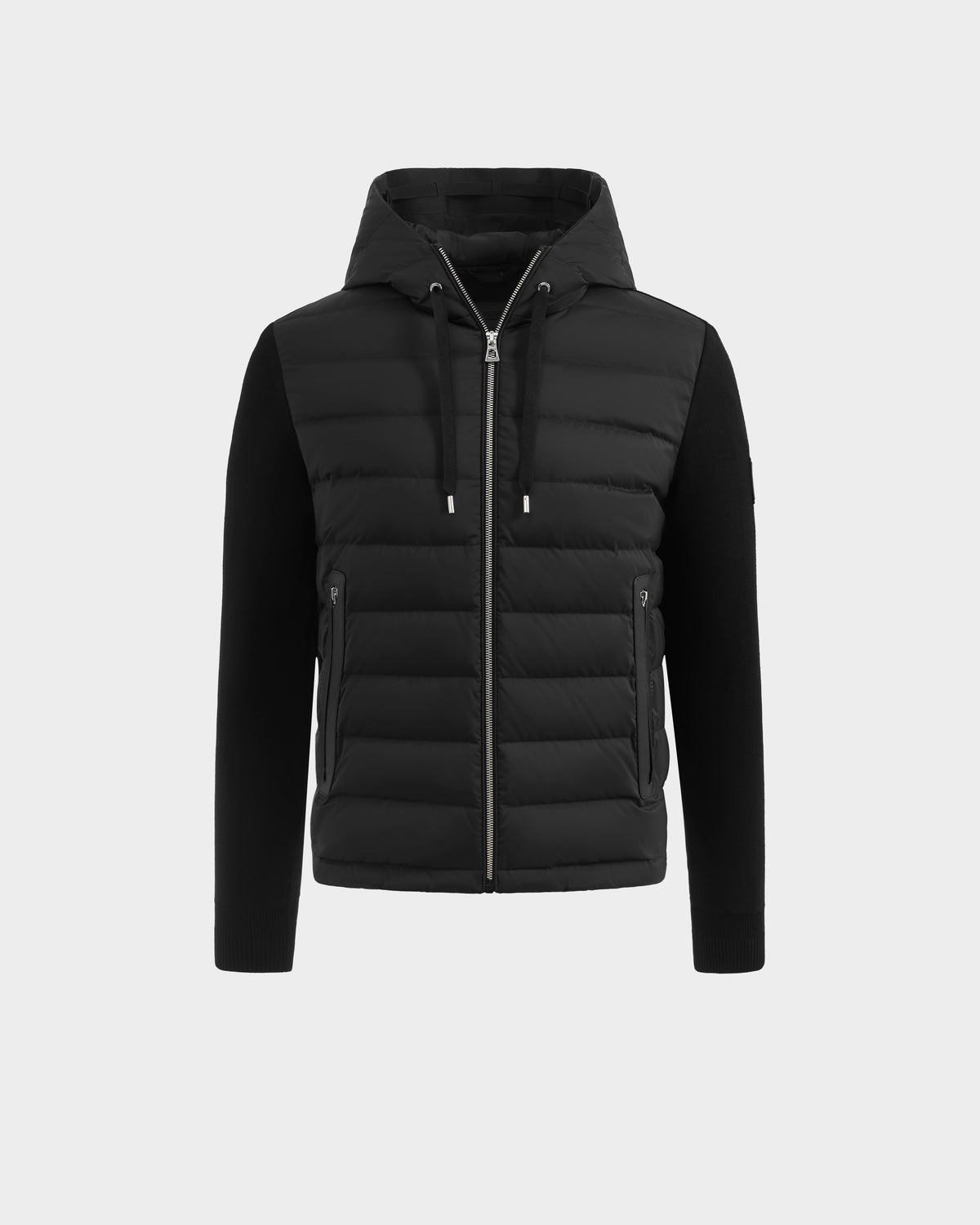 The Rudsak RIVER - 6124584 Black hybrid men's jacket features a quilted, padded front with a zip closure, adjustable drawstrings on the hood, and side zip pockets. The sleeves and sides are crafted from a smoother fabric for contrast and comfort. Shown on a plain white background, this stylish hooded down jacket combines function and fashion.