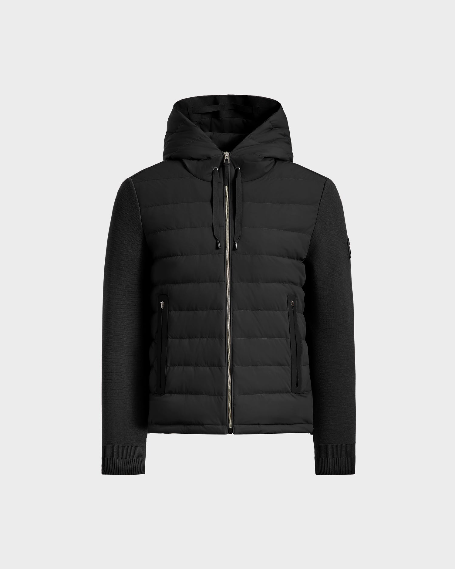 The Rudsak RIVER HV - H125503 Black is a limited edition black hybrid down jacket featuring a quilted front, knit sleeves, ribbed cuffs, zippered closure, and two zippered side pockets, shown against a plain light background.