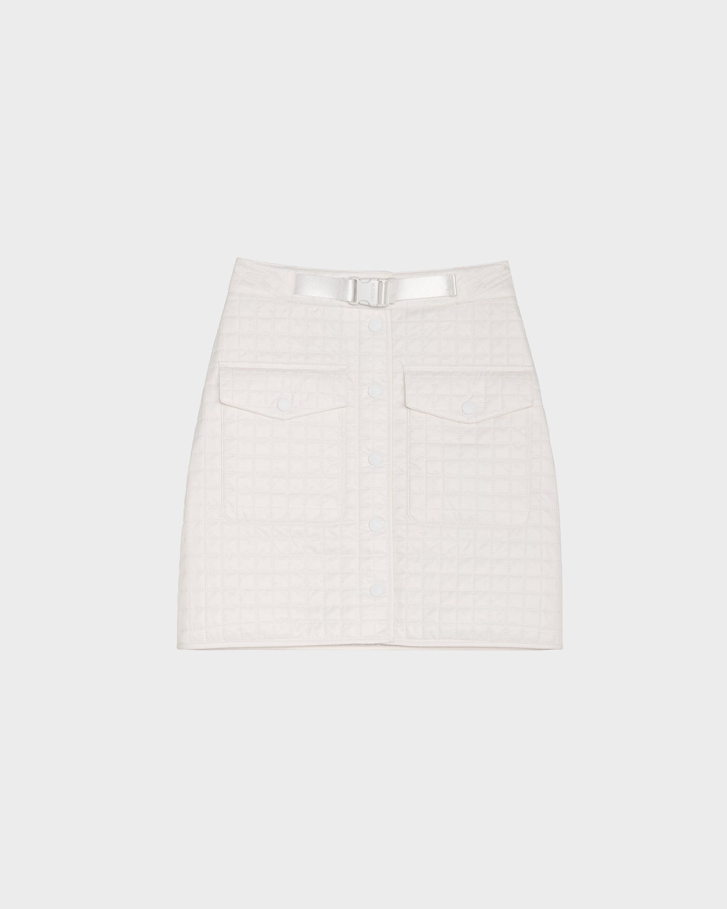 The Rudsak SABINE - 8524063 Eggshell is a white quilted short skirt with front buttons, large front pockets, and a matching belt with metallic buckle—an elegant women’s statement piece shown on a plain light background.