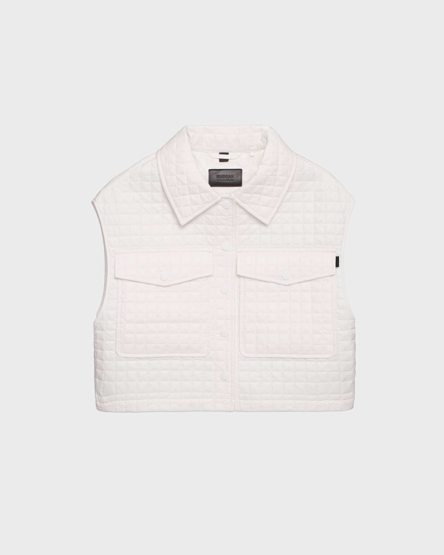 The SOLSA - 8124048 Eggshell by Rudsak is a women’s sleeveless white cropped quilted vest with a collar and two front flap pockets, filled with eco-friendly Sorona fill, shown against a plain light background.