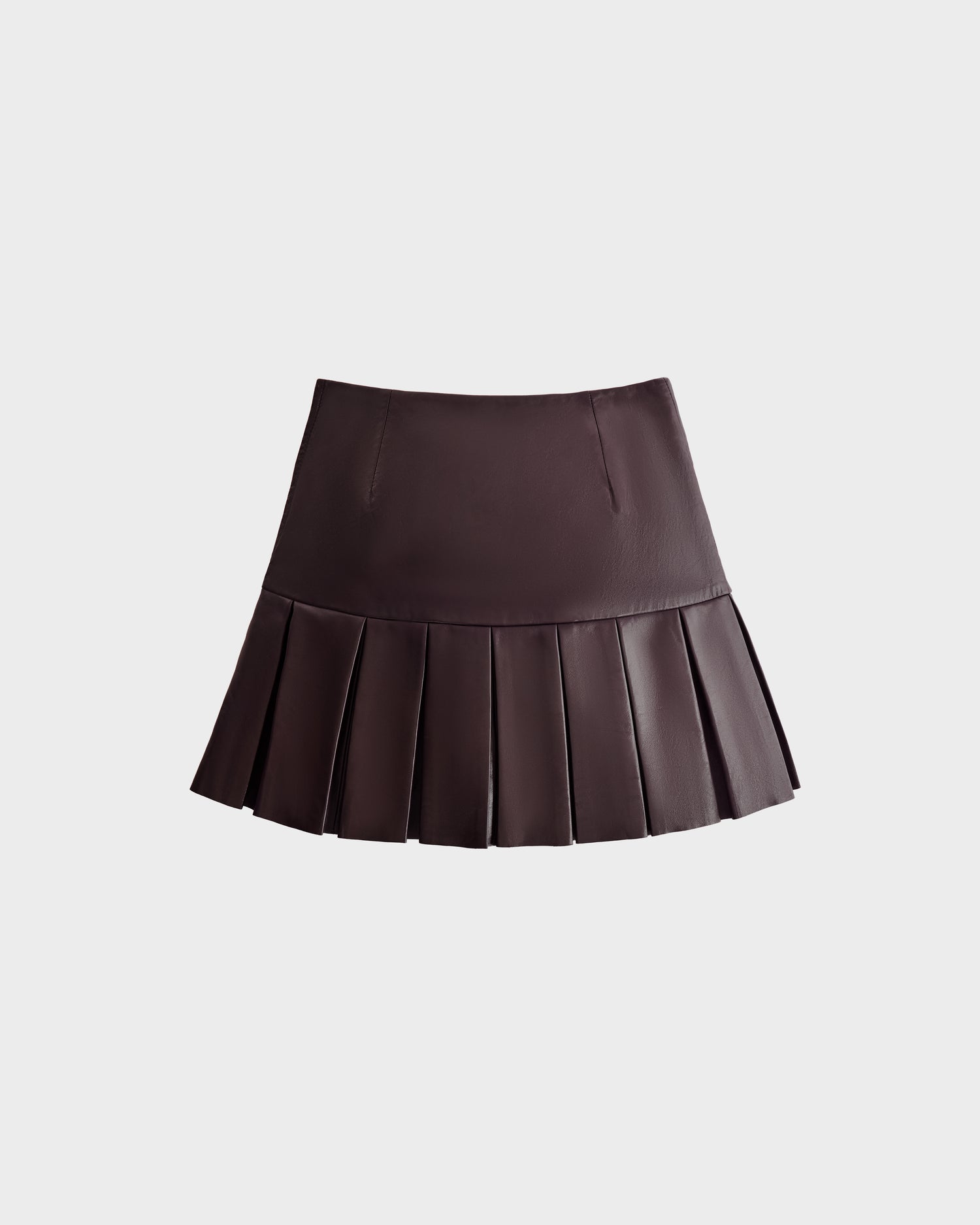 The Rudsak SOLANGE - 8524543 Bordeaux is a chic women's mini skirt in dark brown leather with sharp pleats and a luxe finish, shown against a plain light gray background.