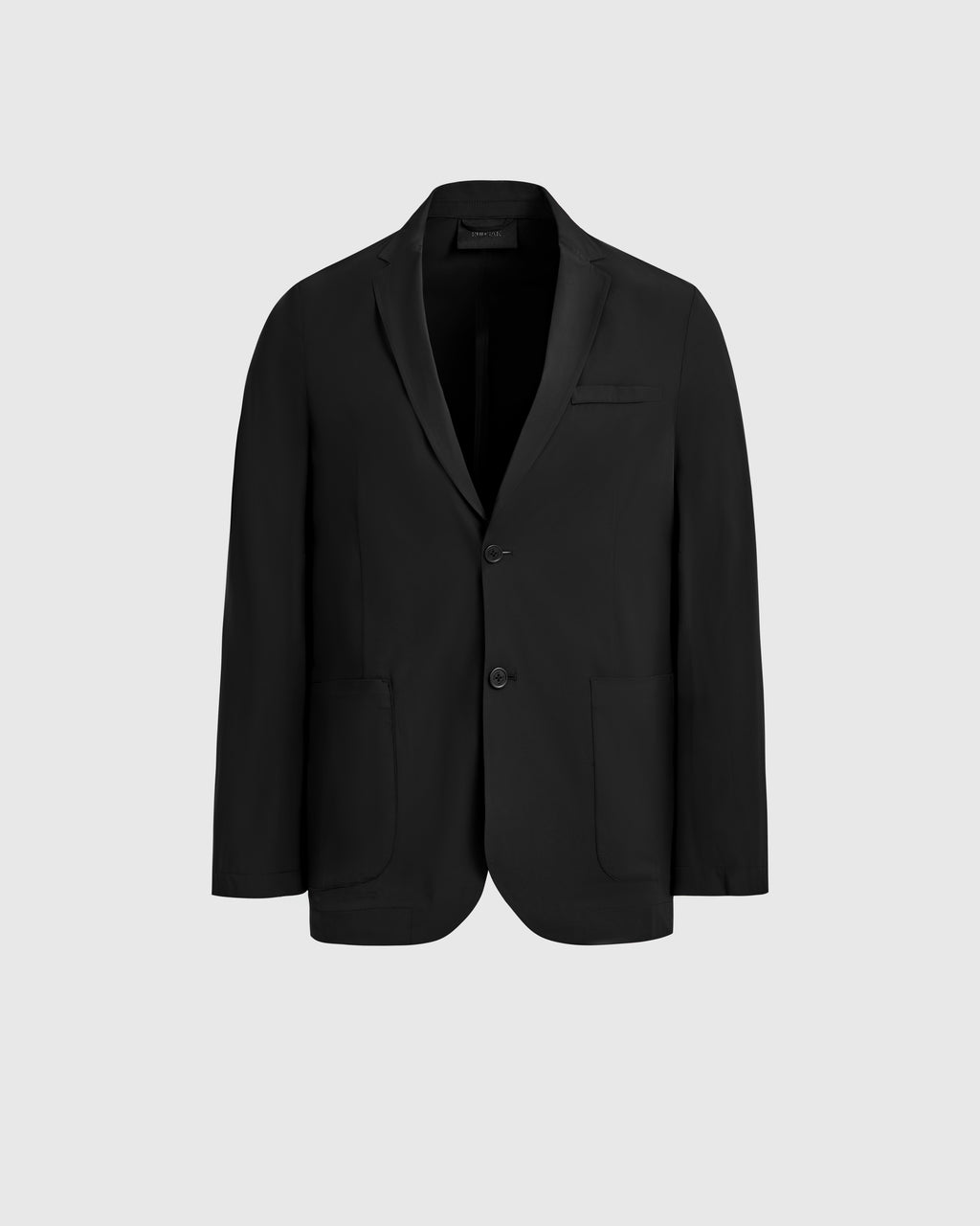 The Rudsak SPENCER - 6525024 Black is a single-breasted blazer with two buttons, notched lapel, and two front pockets—an essential modern wardrobe piece—shown on a plain light gray background.