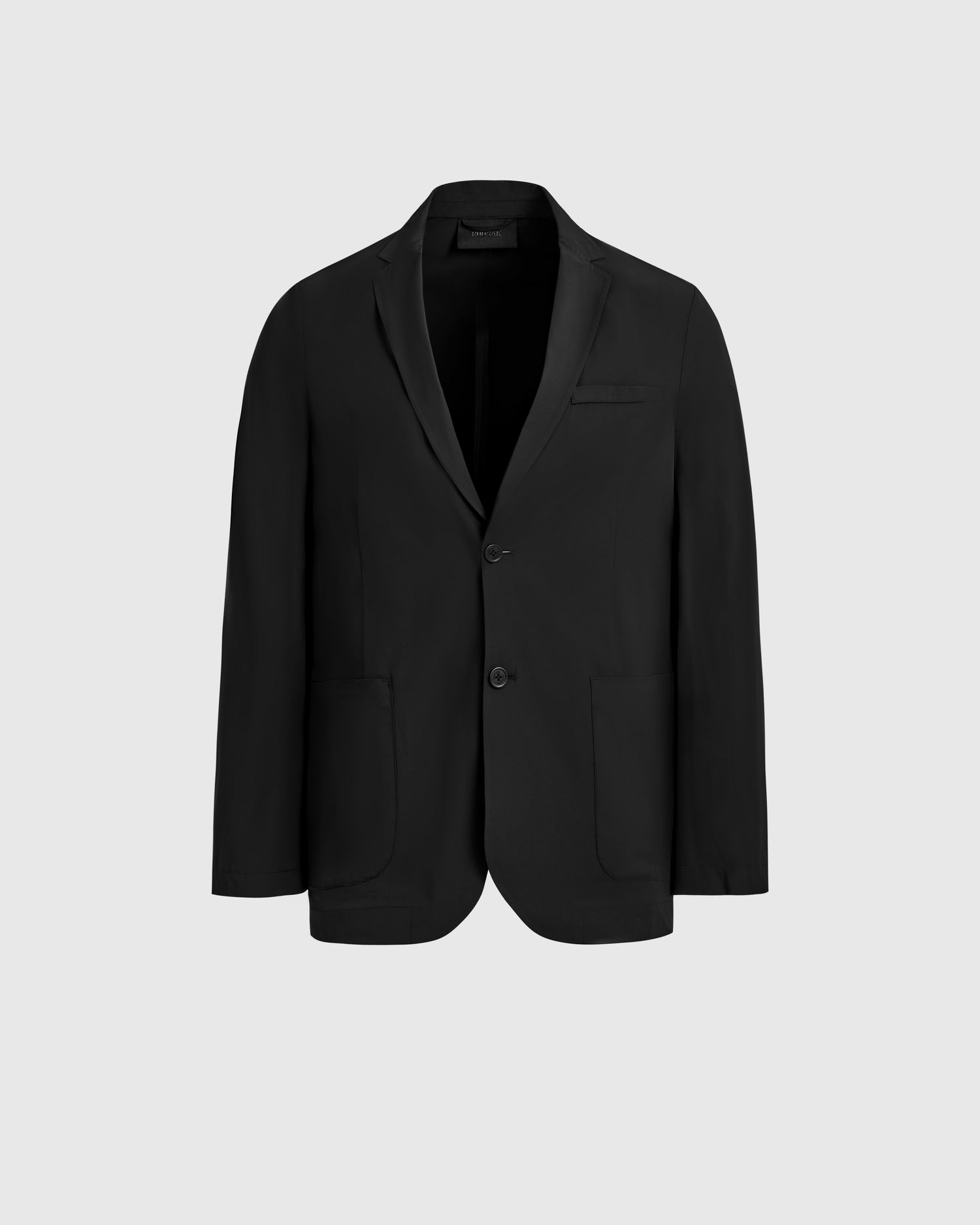 The Rudsak SPENCER - 6525024 Black is a single-breasted blazer with two buttons, notched lapel, and two front pockets—an essential modern wardrobe piece—shown on a plain light gray background.