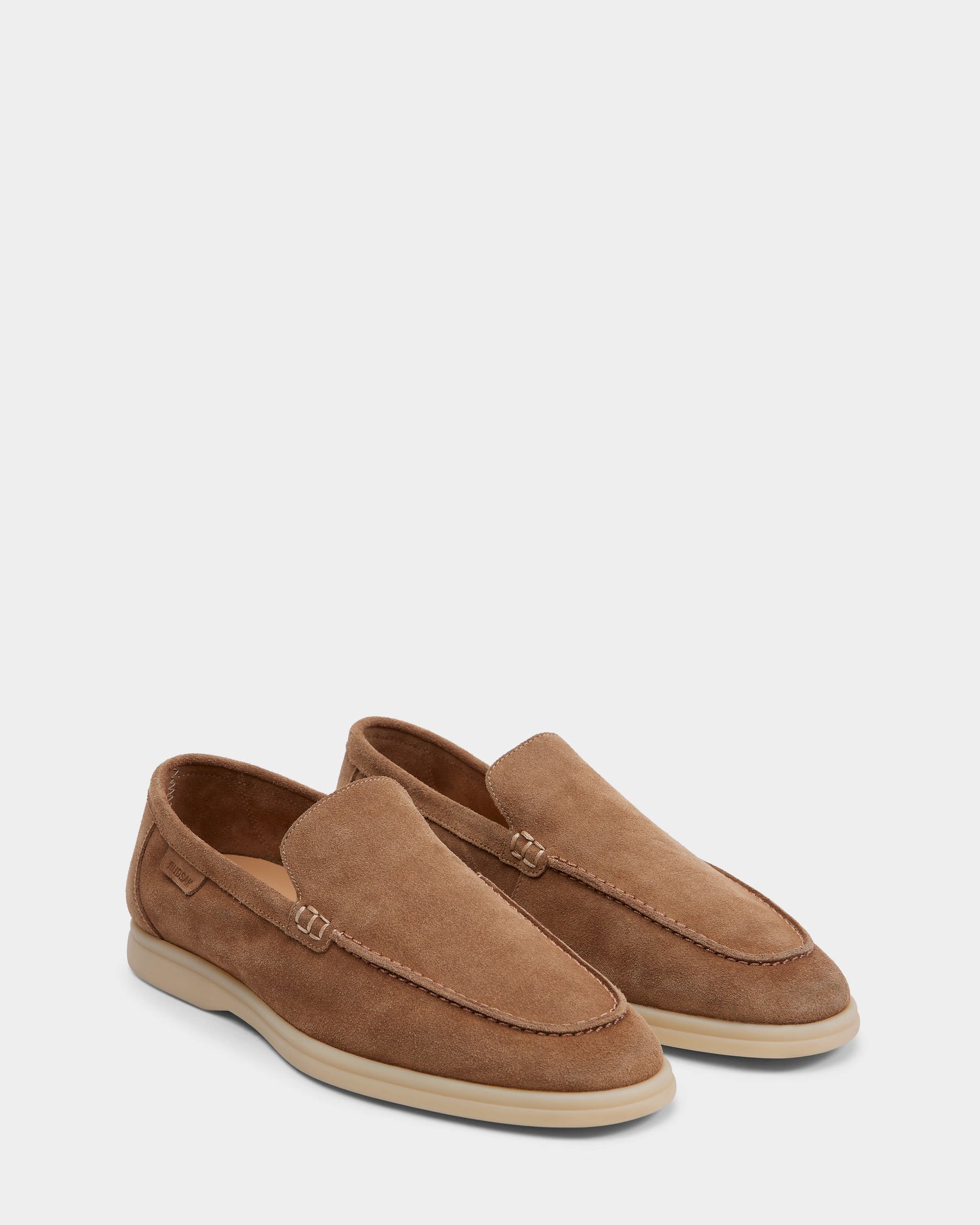 Rudsak’s CHANNING - 6225005 Almond are light brown men’s suede loafers with stitching detail and white rubber soles, shown on a plain white background—ideal slip-on footwear for men seeking premium style.