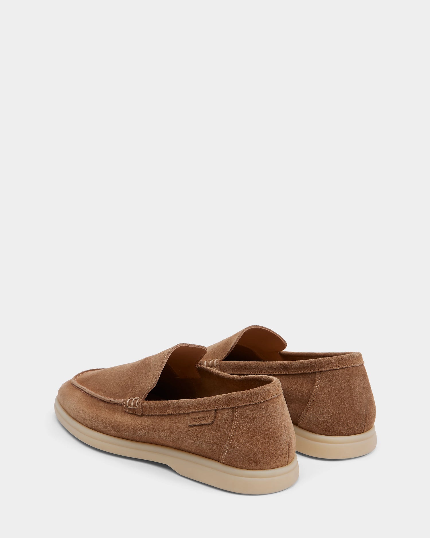 The Rudsak CHANNING - 6225005 Almond mens loafers are brown suede slip-ons with light soles, displayed from the back and side on a plain white background.