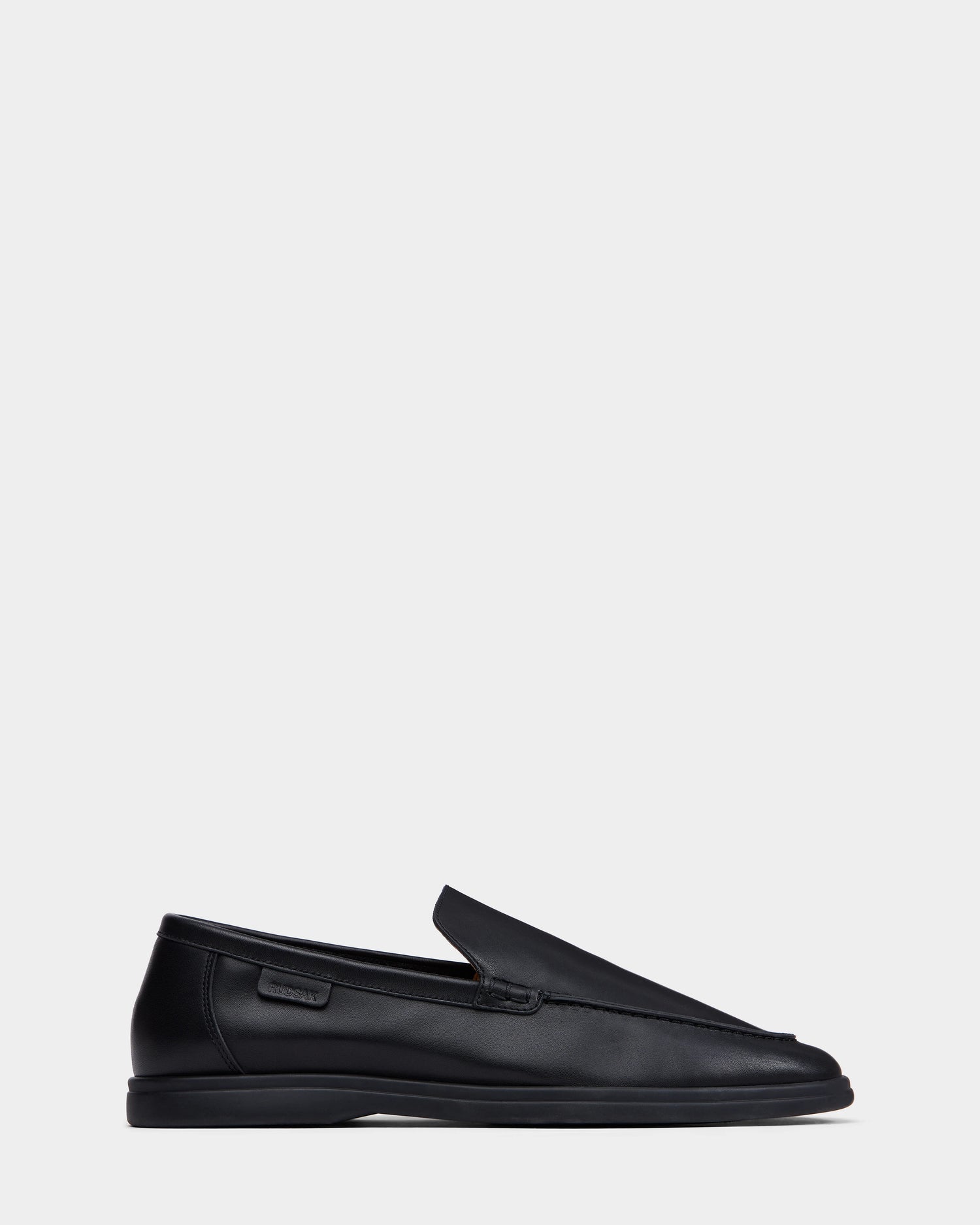 The Rudsak CHANNING - 6225005 Black, a premium mens leather loafer, is showcased against a white background.