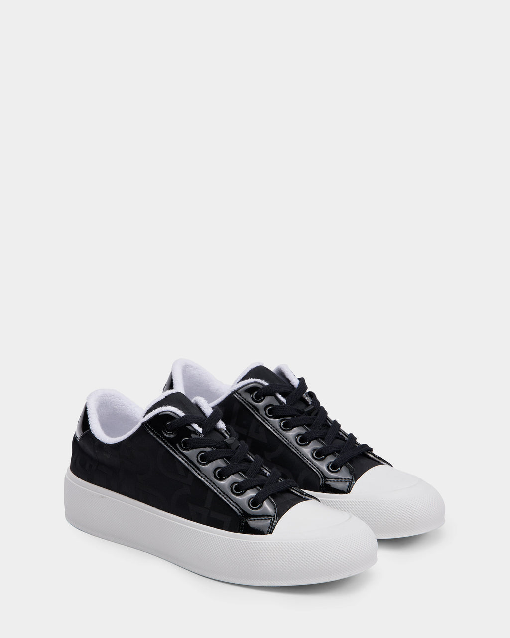 The Rudsak RIMA - 8225001 Black Pattern women’s platform sneakers feature black uppers, white rubber toe caps and soles, black laces, and a white inner lining, shown on a plain light background.