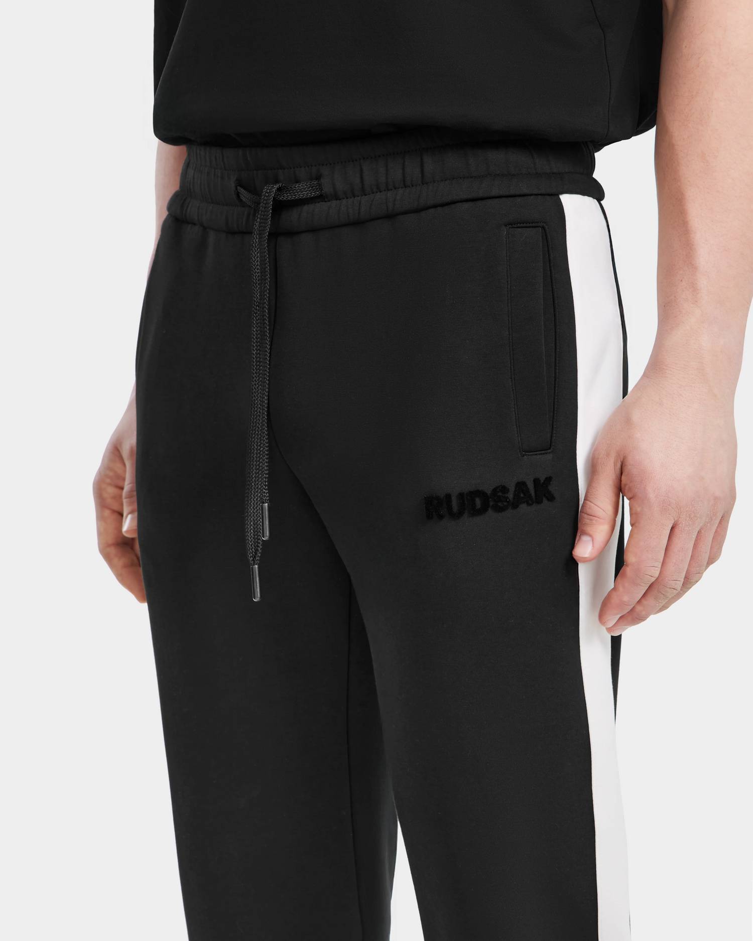 A person wearing Rudsak RYLAN - 6525009 joggers in black with a modern design.