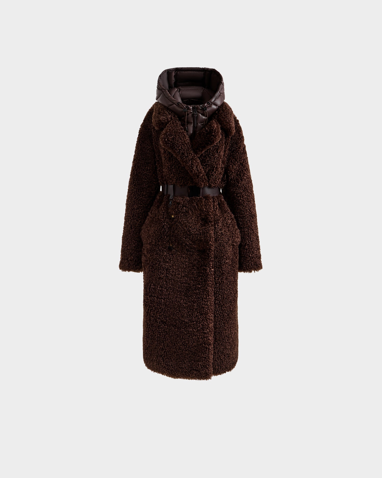 The Rudsak TINA - 8125968 Espresso is a long, dark brown faux fur teddy trench coat with a belted waist, wide lapels, and a shiny padded removable hooded bib, shown against a plain light gray background.