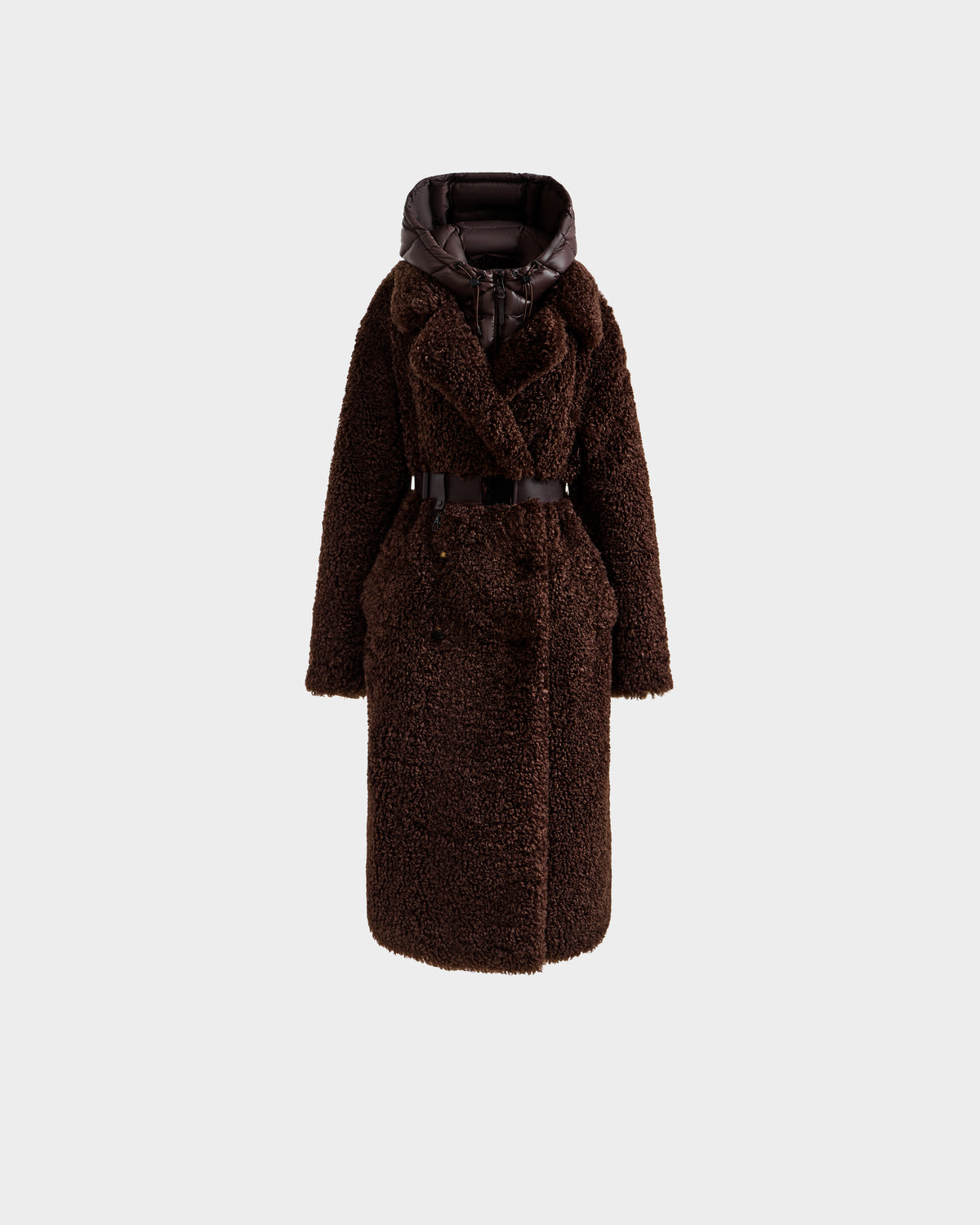 The Rudsak TINA - 8125968 Espresso is a long, dark brown faux fur teddy trench coat with a belted waist, wide lapels, and a shiny padded removable hooded bib, shown against a plain light gray background.