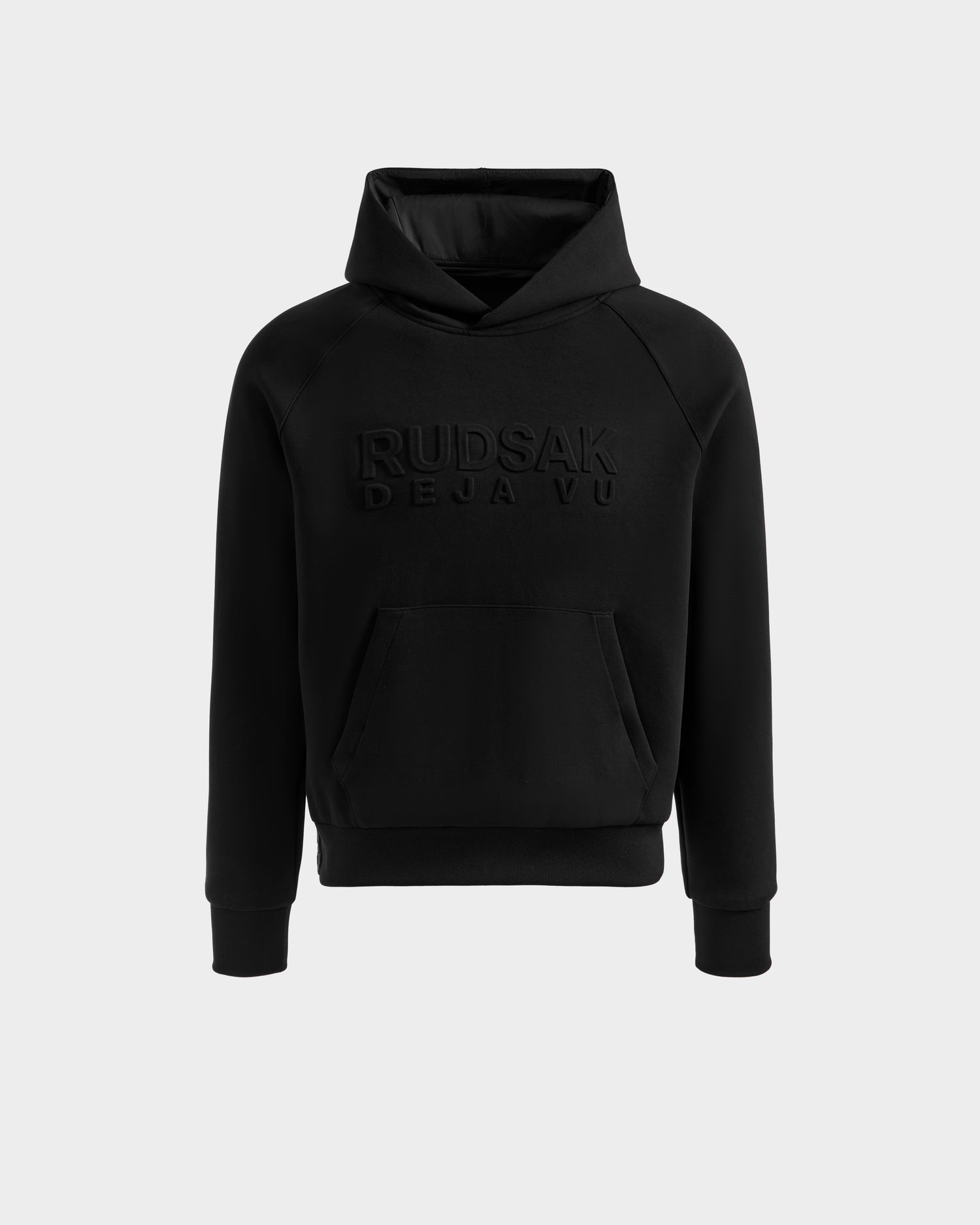 The Rudsak TREVIS - 6525599 Black hoodie features a front kangaroo pocket and embossed DEJA VUE text on the chest, shown against a plain light background.
