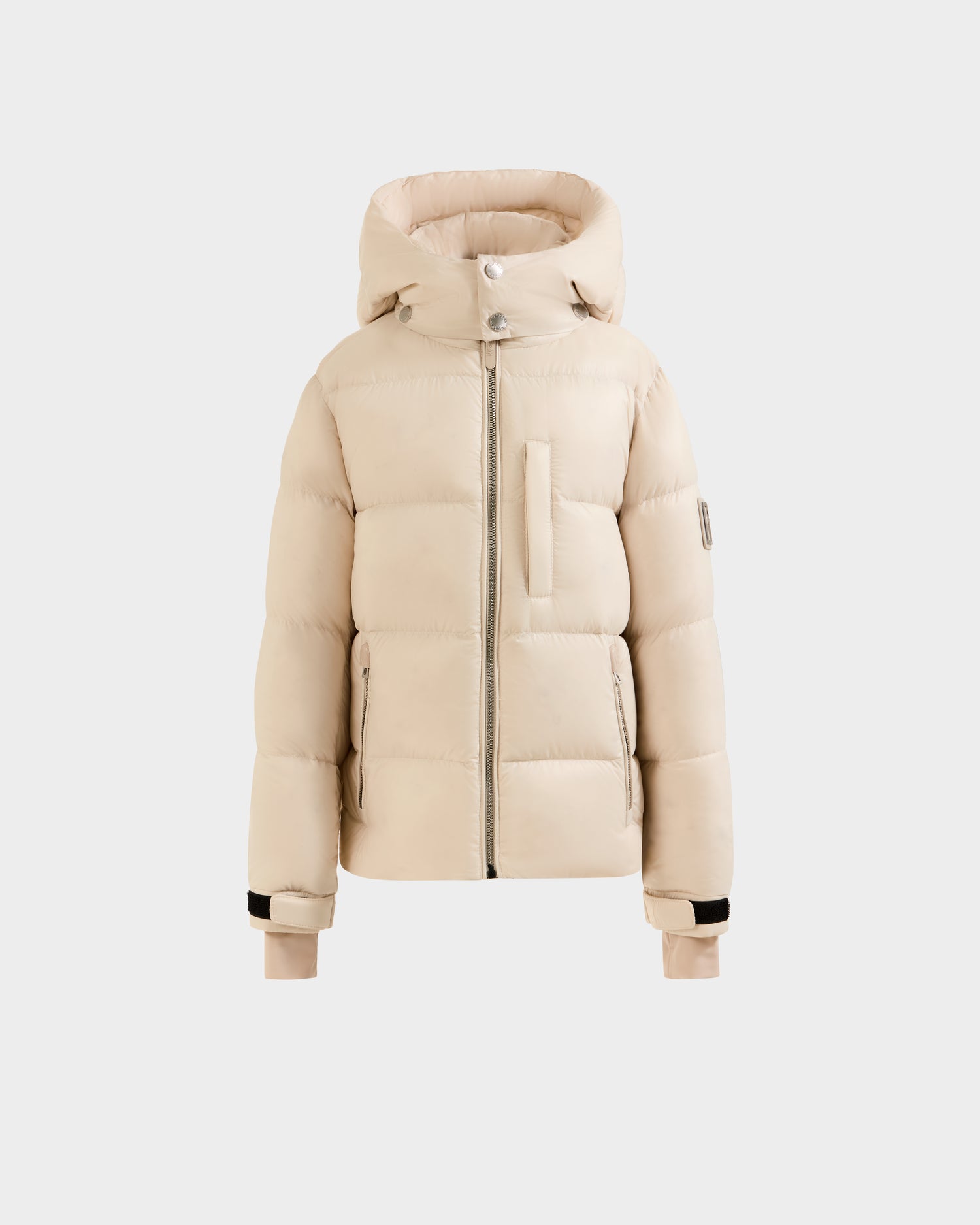 The Rudsak VINCE KS - 0124502 Vanilla is a unisex beige puffer jacket with RDS-certified down, high collar, hood, front zipper, chest pocket, and ribbed cuffs—shown on a plain white background.