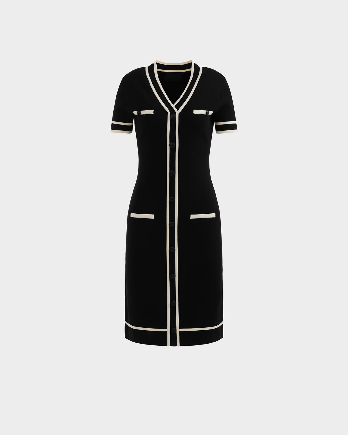 The VINNIE - 8526038 Black by Rudsak is a knee-length, short-sleeved black knit midi dress with white trim, V-neckline, front buttons, and four white-edged pockets—two chest and two hip—shown on a plain white background.