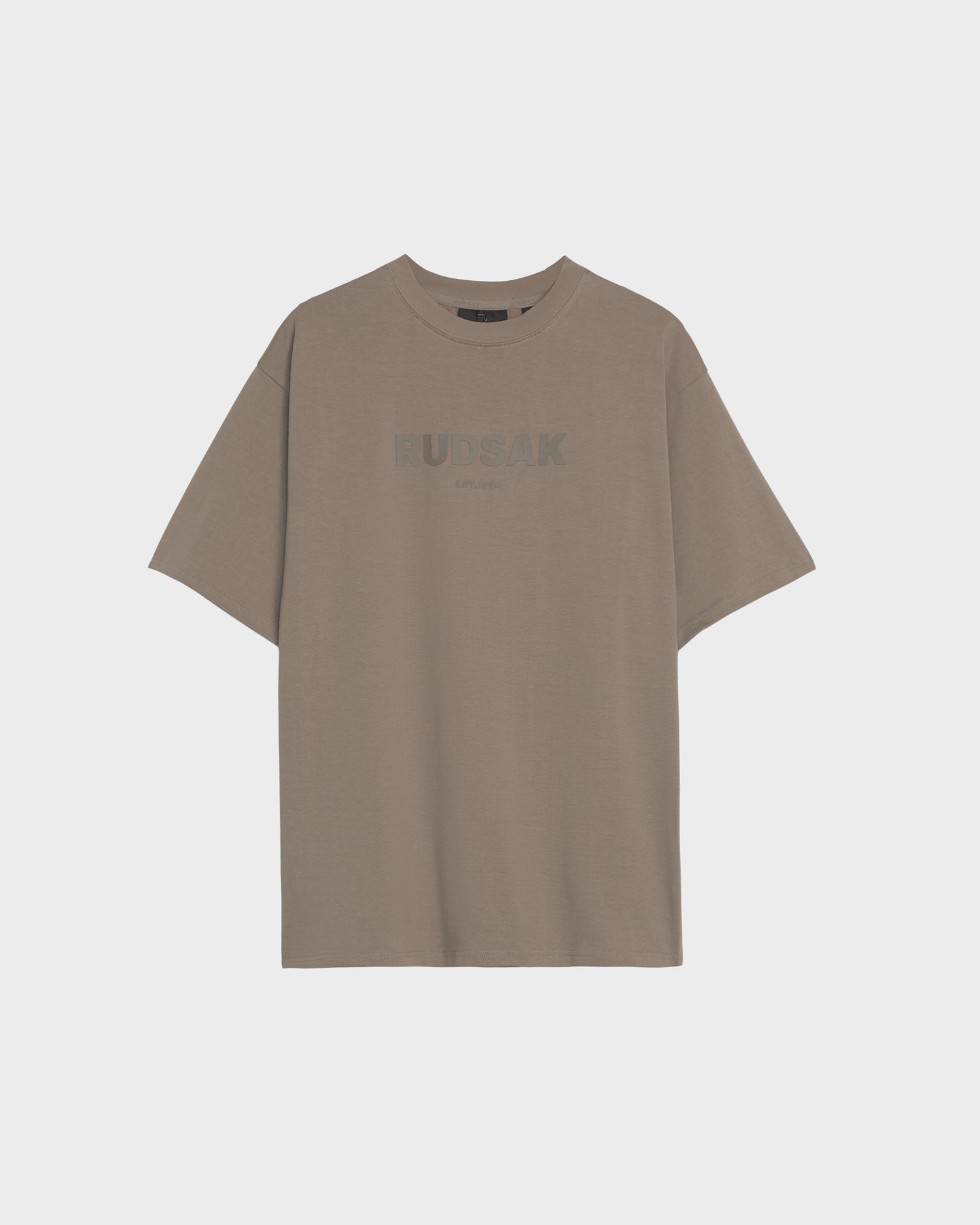 The KARTER - 9524008 Cement W by Rudsak is an oversized unisex taupe T-shirt in premium cotton, with short sleeves, a crew neck, and subtle RUDSAK branding on the front center.