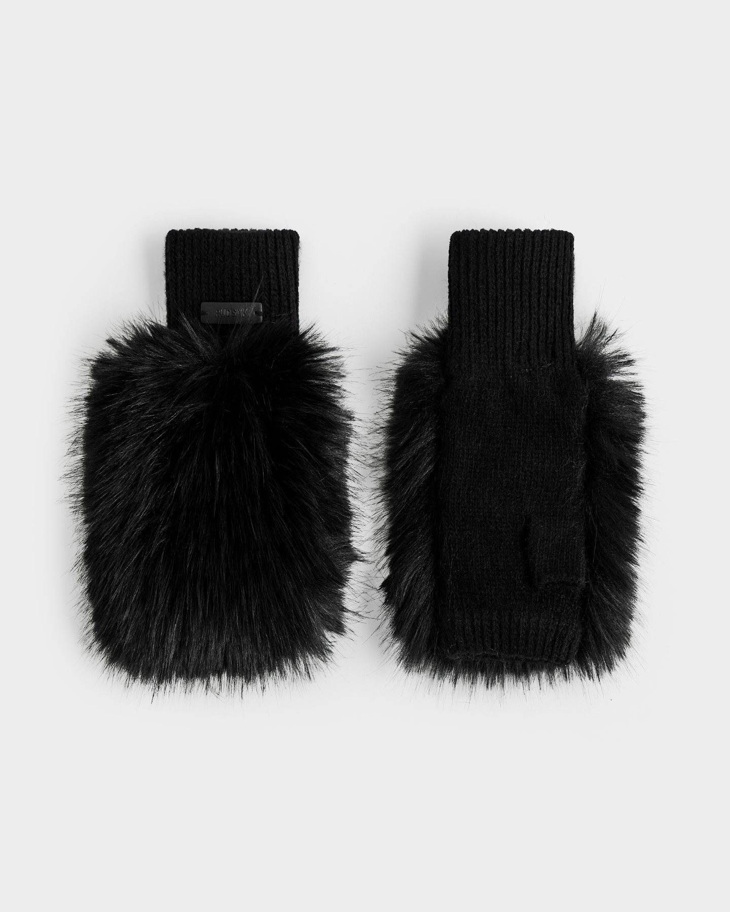 The Rudsak LIA - 8425007 Black women’s mittens feature thick faux fur on top, a wool-blend knit body, and ribbed cuffs, shown in black on a plain light gray background.